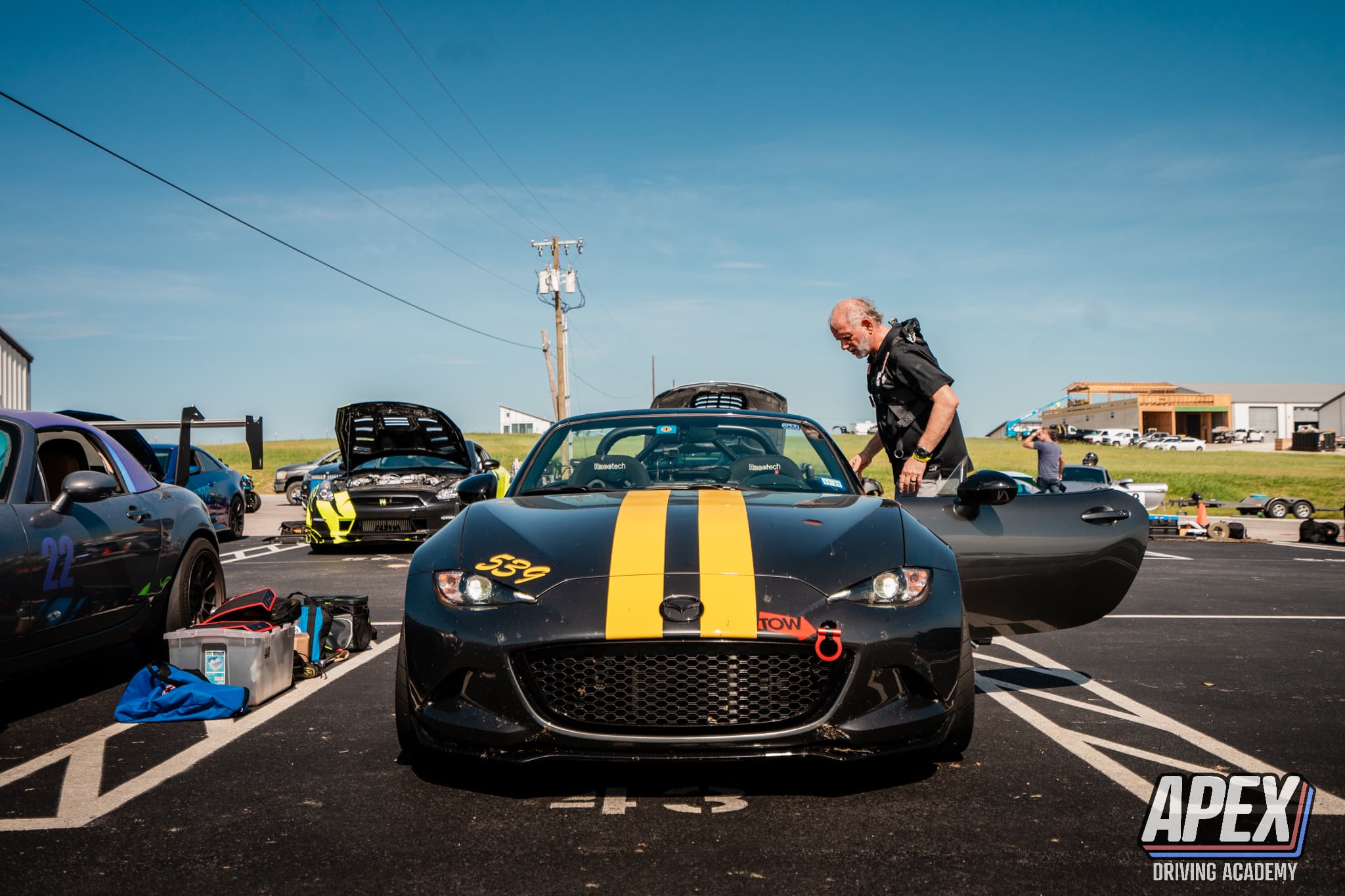 539 Mazda race car and driving instructor in the racetrack paddock